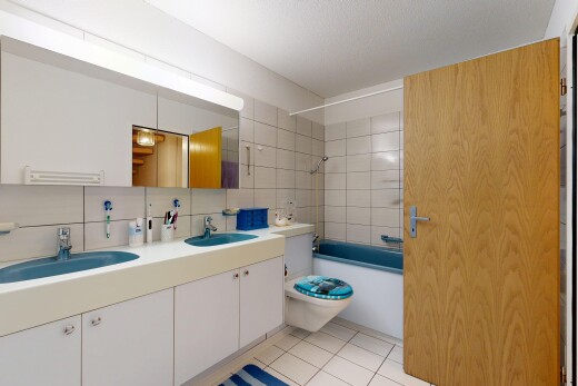 bathroom with double vanity,  shower combination, light tile patterned floors, and tasteful backsplash