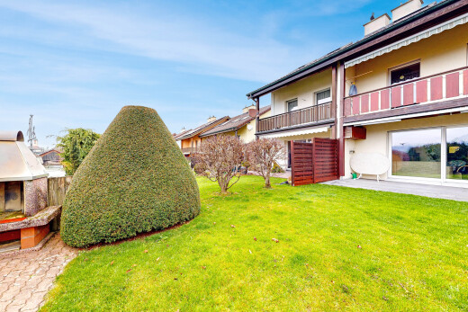 garden featuring a lawn and a balcony