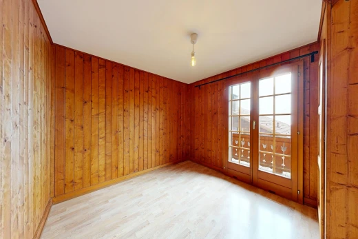 pièce vide avec dated wood wall, mur en bois, wood wall, sol en finition bois, et wood finish floor