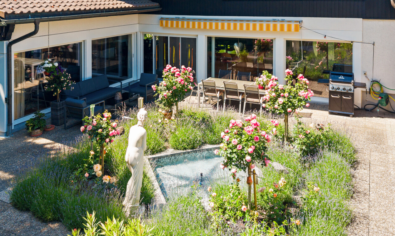 garden featuring a patio, area for grilling, and outdoor dining area