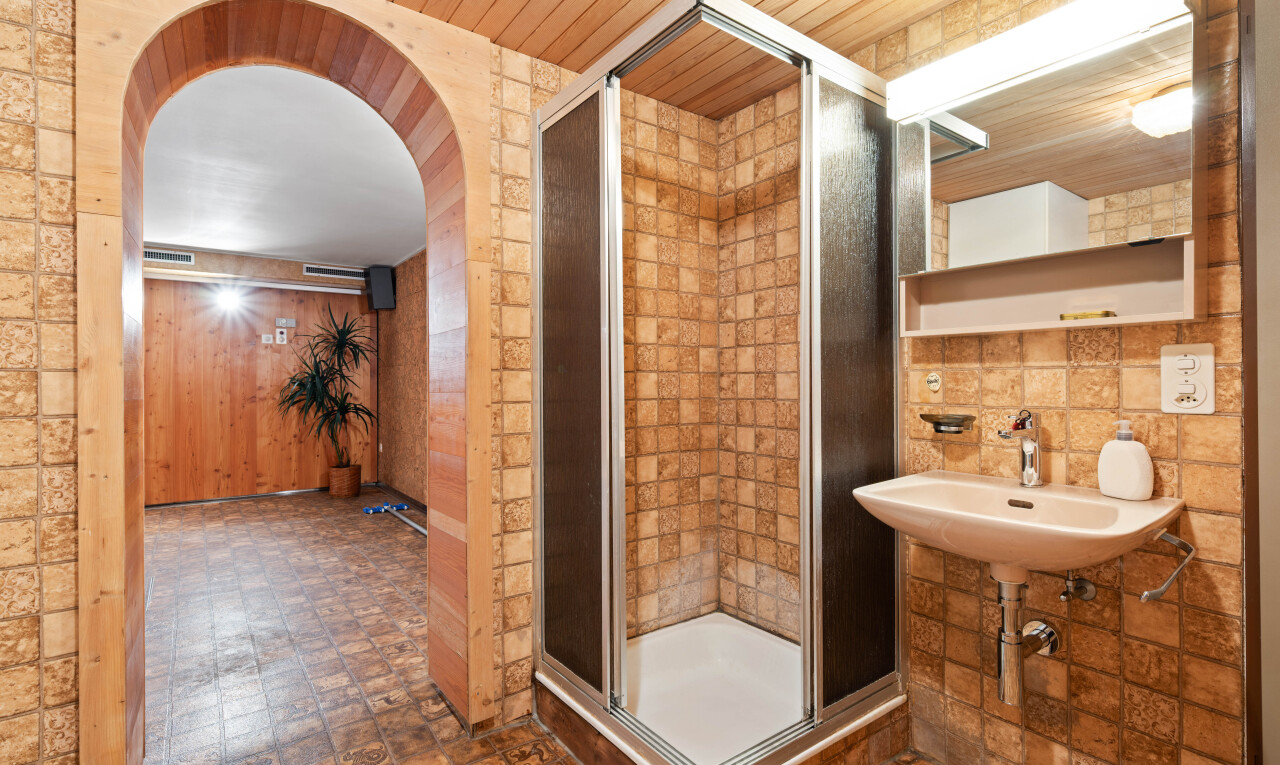 bathroom with a stall shower and wooden ceiling