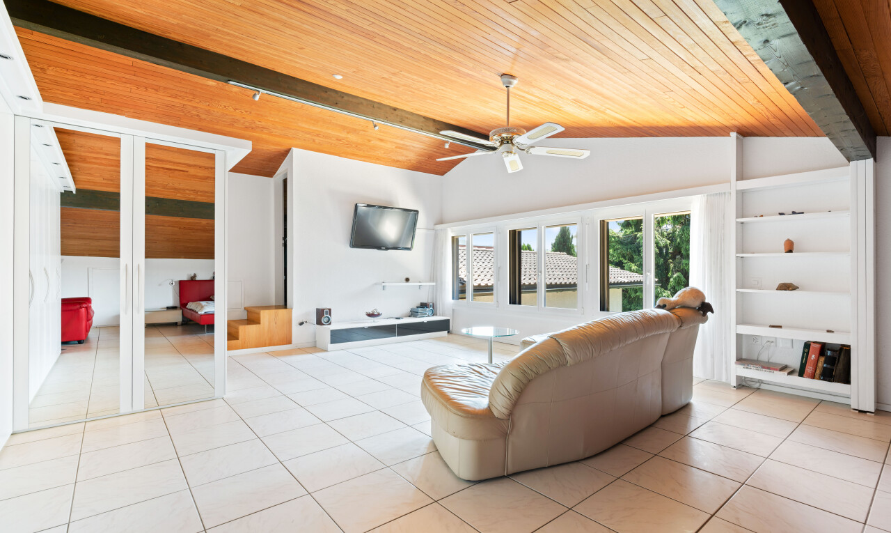 living area with built in features, wood ceiling, a ceiling fan, lofted ceiling with beams, and light tile patterned floors