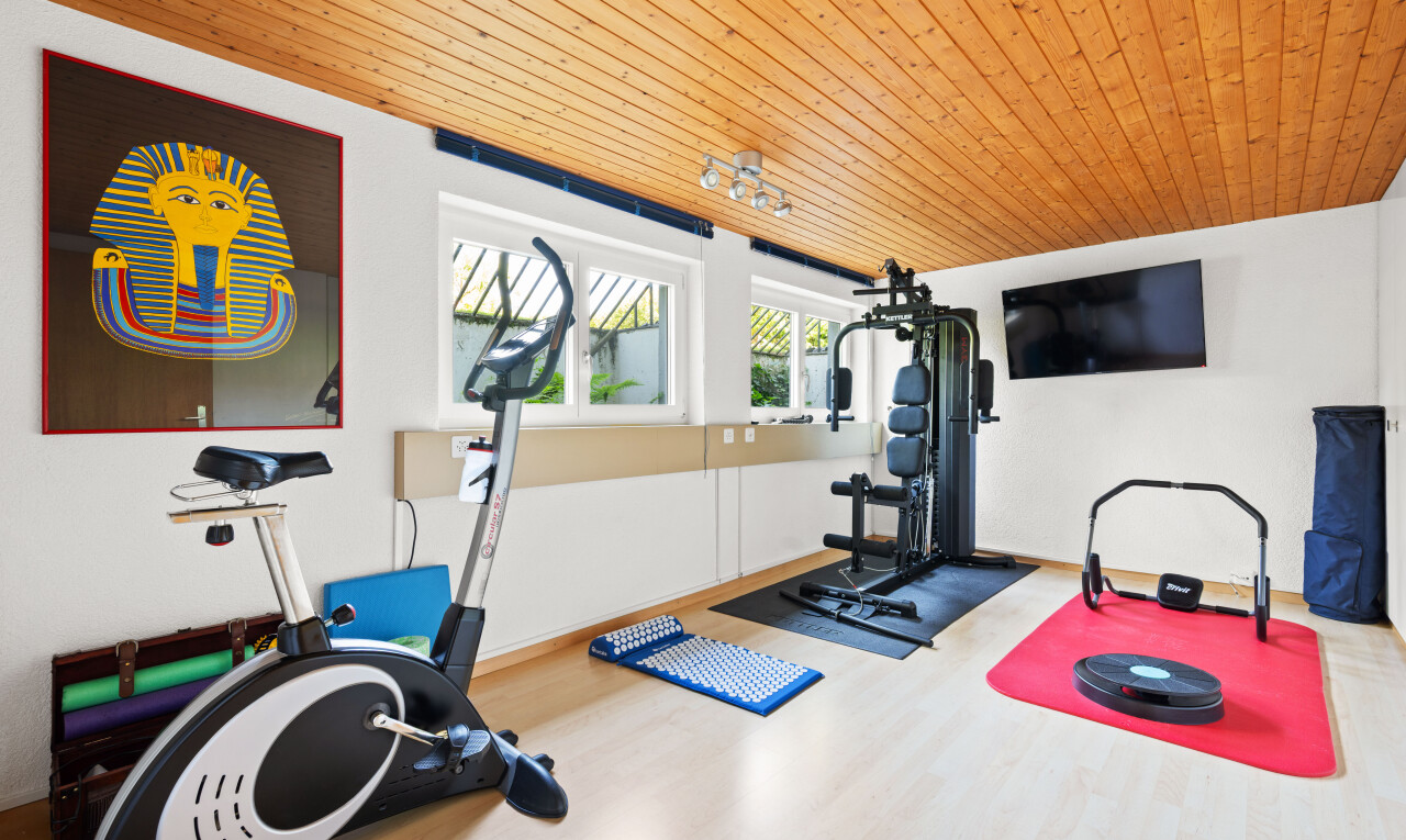 workout area with wooden ceiling and wood finished floors