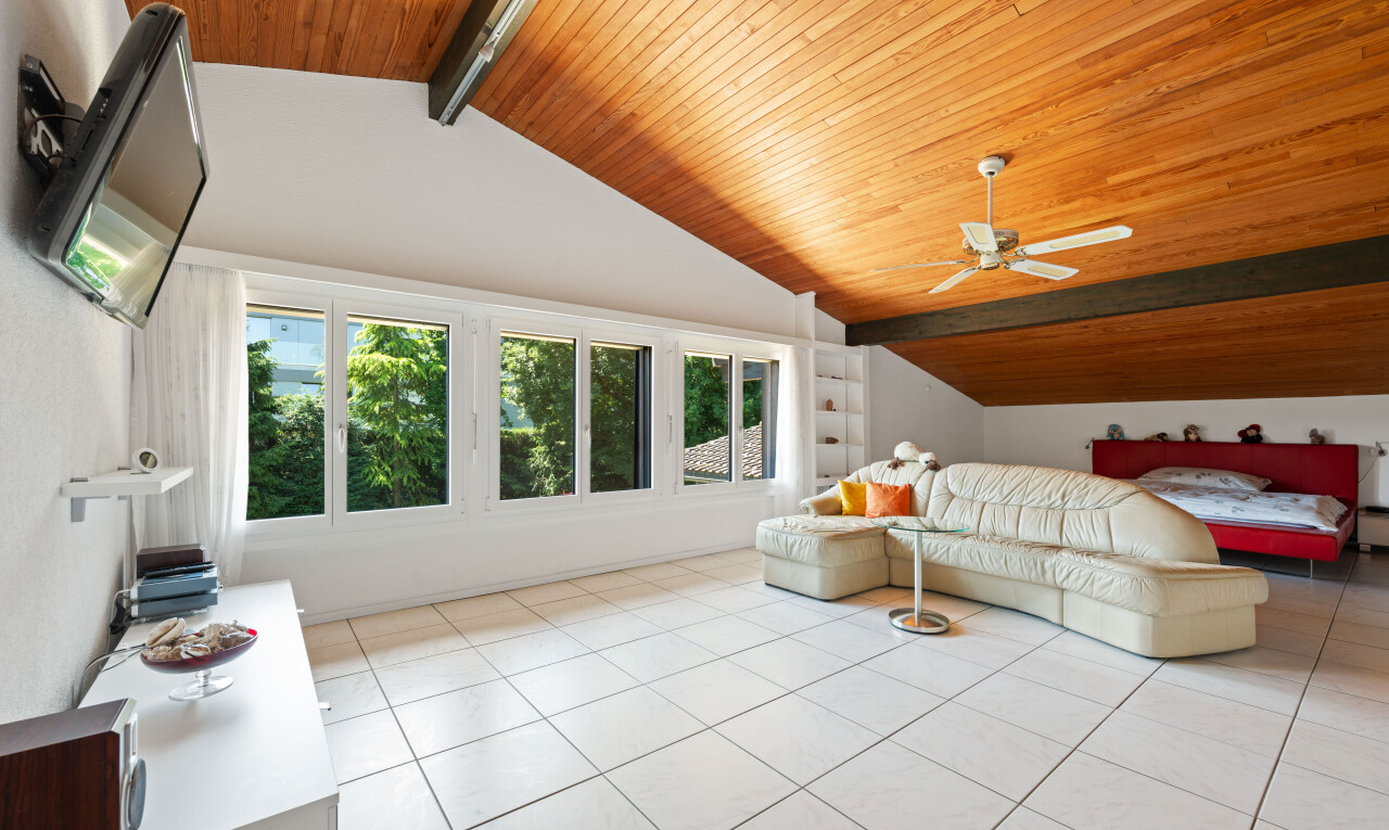 room with a high wood beamed ceiling, light tile patterned floors, built in features, and ceiling fan