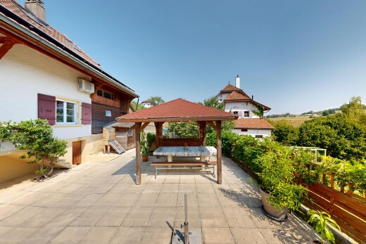 view of home with a gazebo, a patio, and a chimney