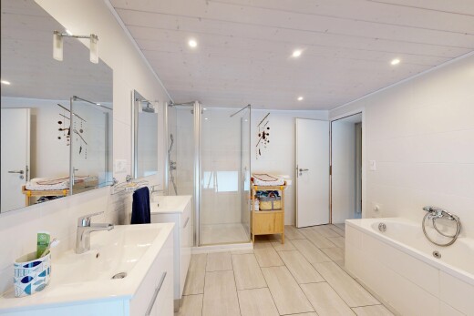 bathroom featuring a stall shower, recessed lighting, a garden tub, and vanity