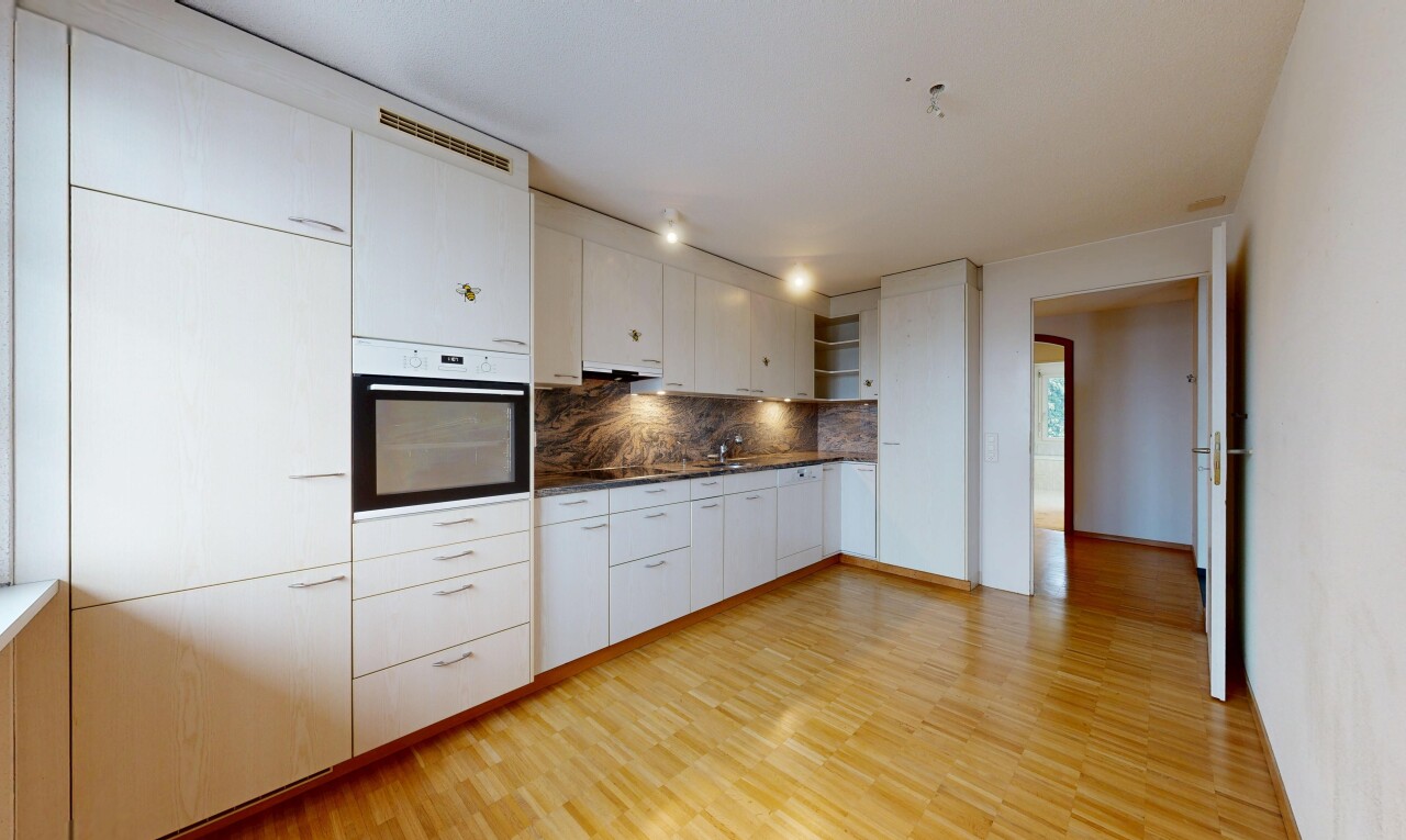 cuisine avec plans de travail, armoires blanches, four, étagères ouvertes, et inside property