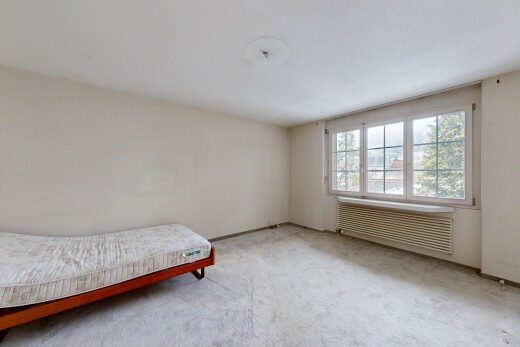 zimmer / schlafzimmer mit gipskartonwand, drywall, kühler, teppich, und carpet