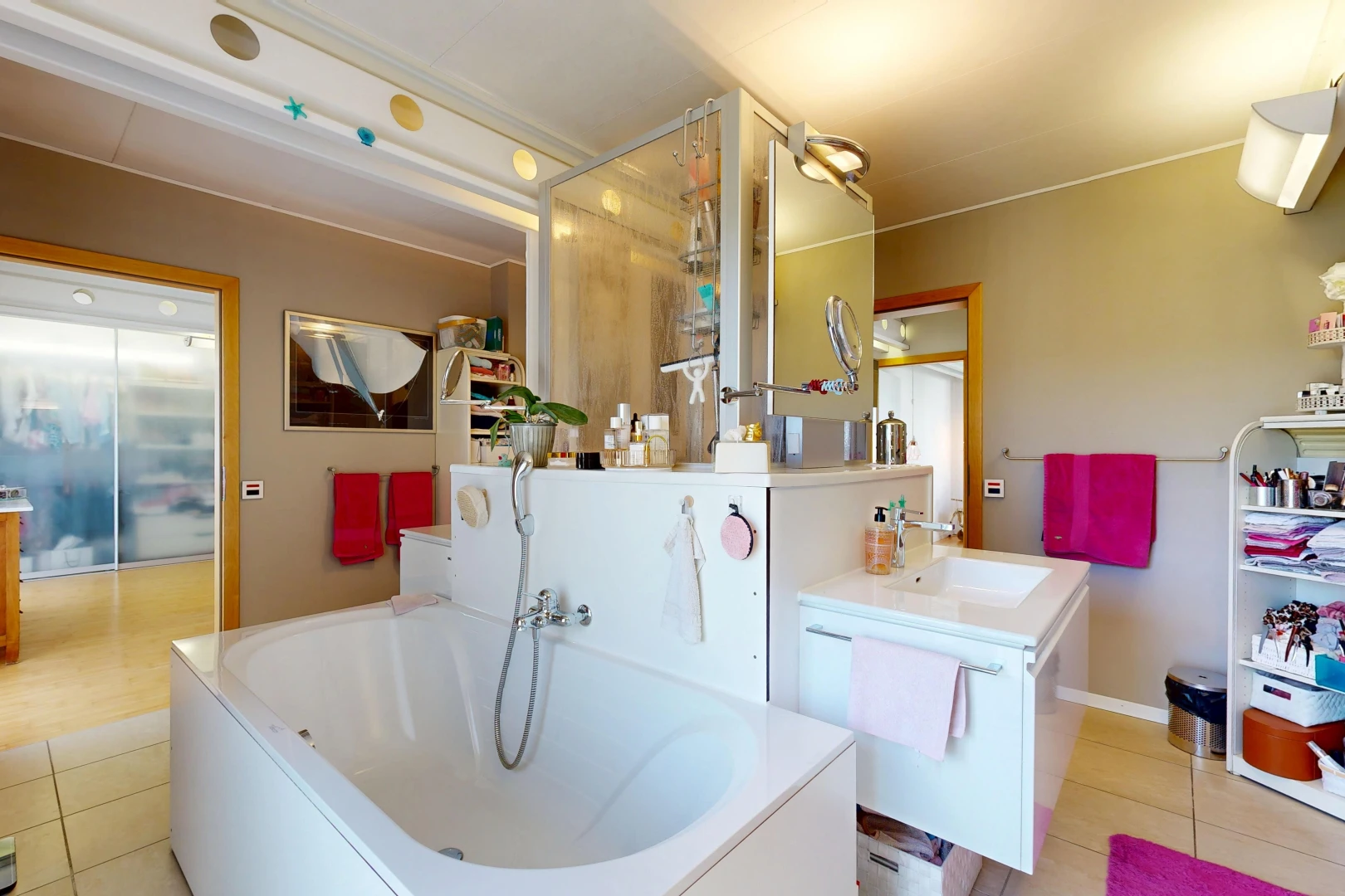 bathroom with a garden tub, vanity, and light tile patterned floors