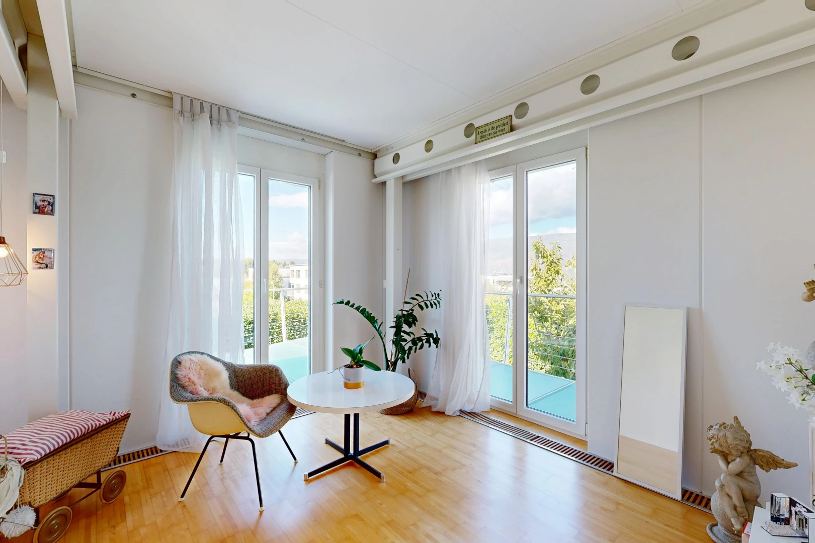 living area featuring light wood-style flooring and access to exterior