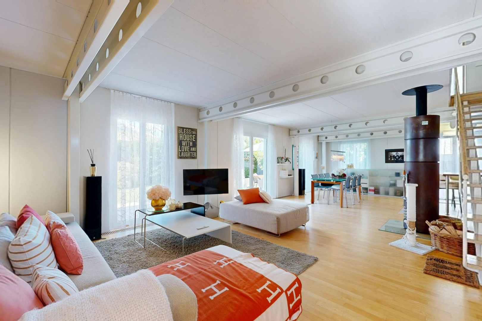 living area featuring rail lighting, light wood-style flooring, and access to exterior