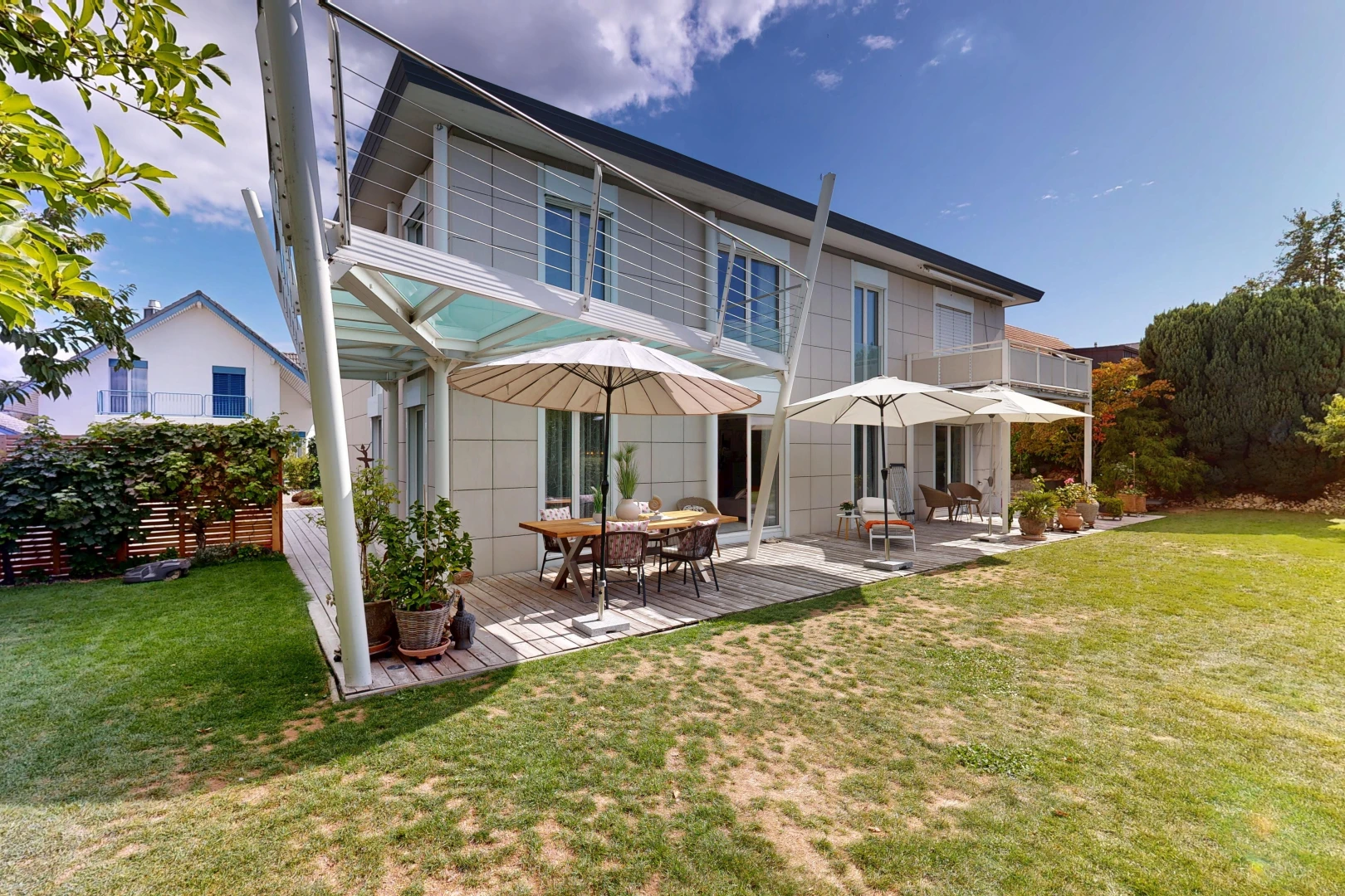 outdoor house with a yard and a deck