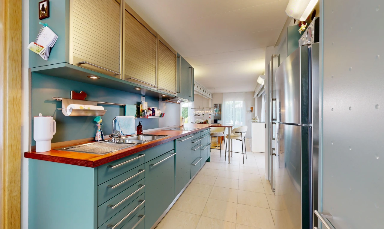 kitchen with freestanding refrigerator, wood counters, and light tile patterned floors