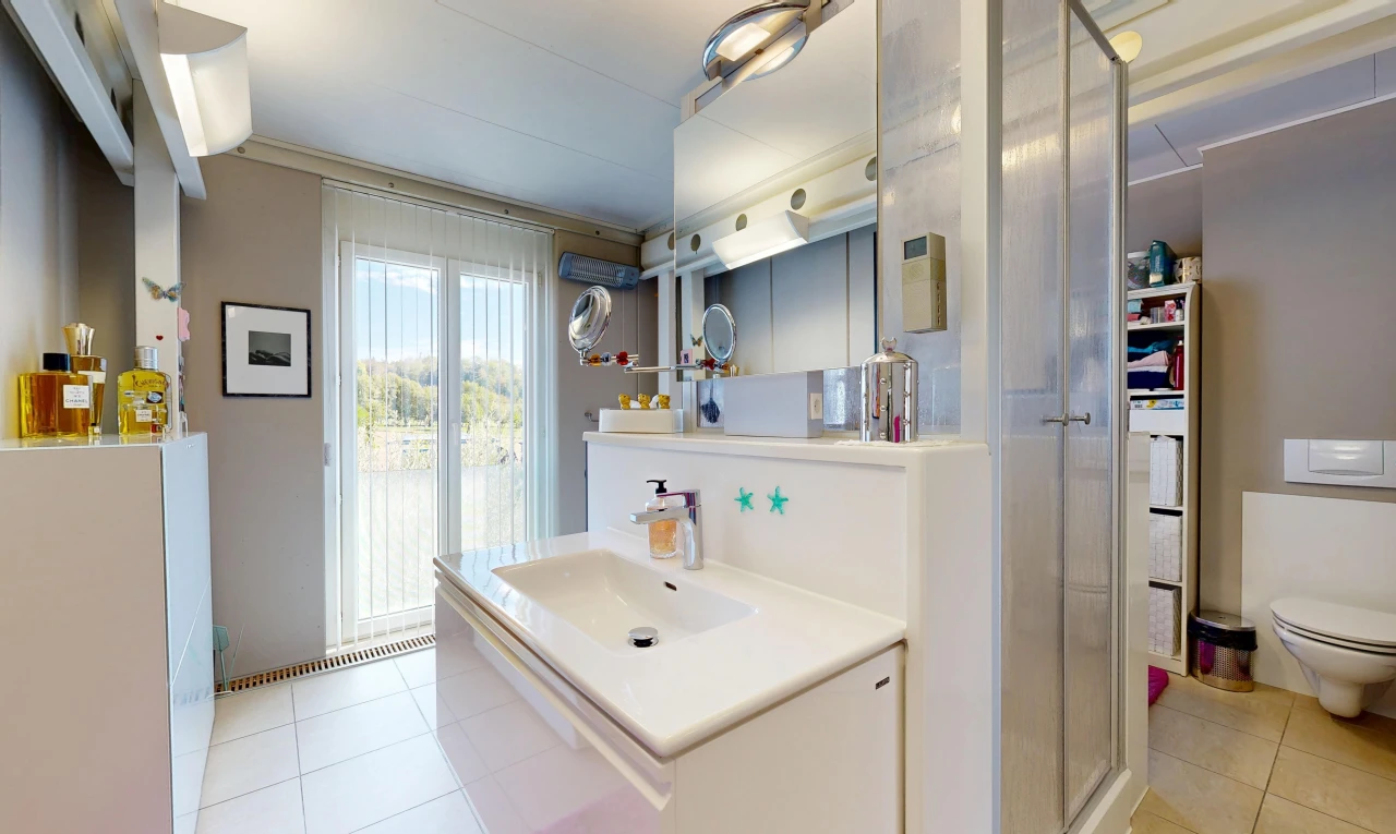 full bathroom featuring a stall shower, vanity, and light tile patterned floors