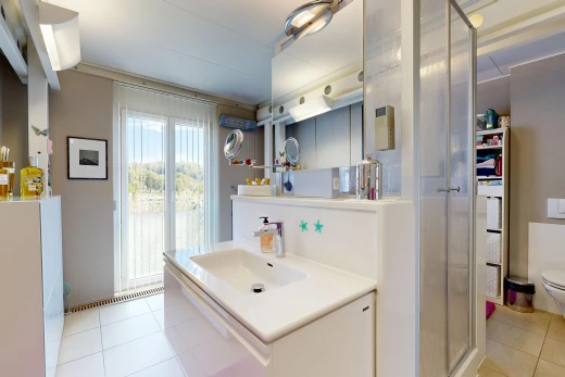 full bathroom featuring a stall shower, vanity, and light tile patterned floors