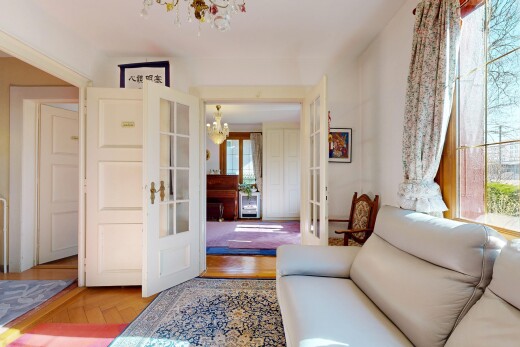 wohnzimmer mit französische türen, gipskartonwand, natürliches licht, und bemerkenswerter kronleuchter