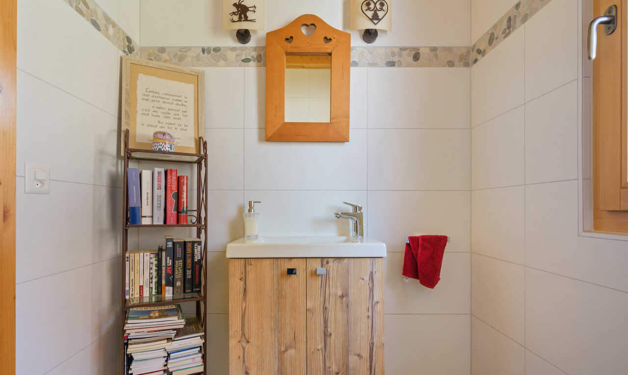 bathroom featuring vanity and tile walls
