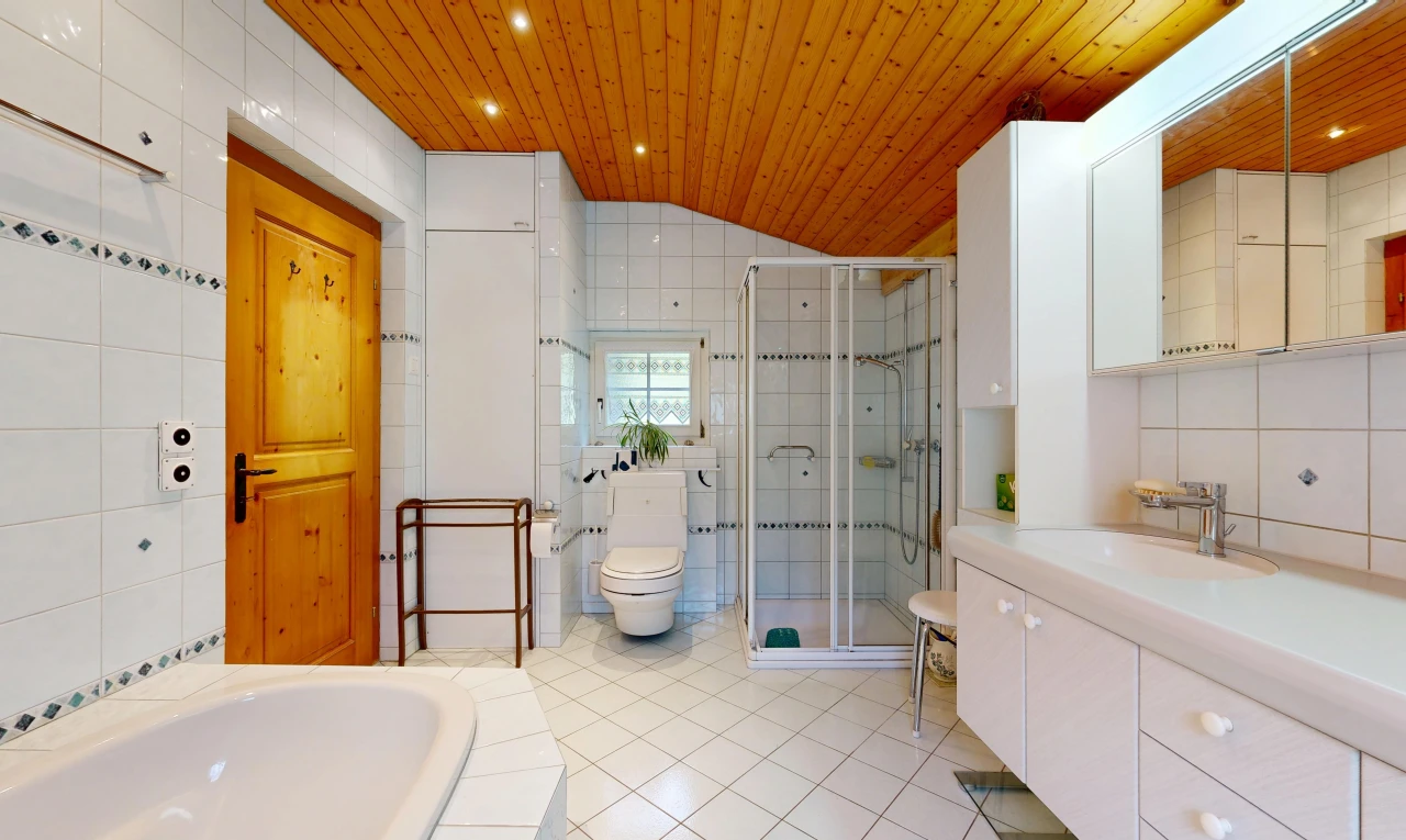 full bathroom featuring tile walls, a stall shower, vanity, a vaulted wooden ceiling, and a garden tub