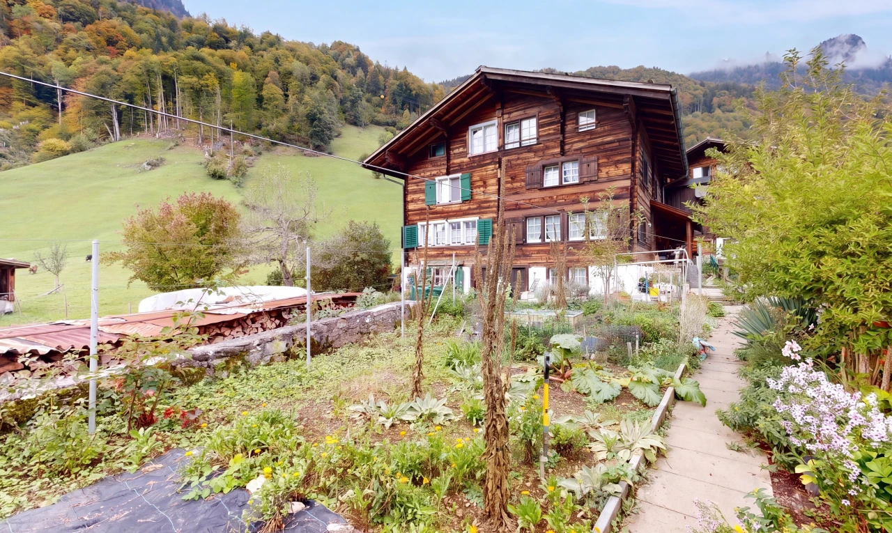 view of property with a wooded view
