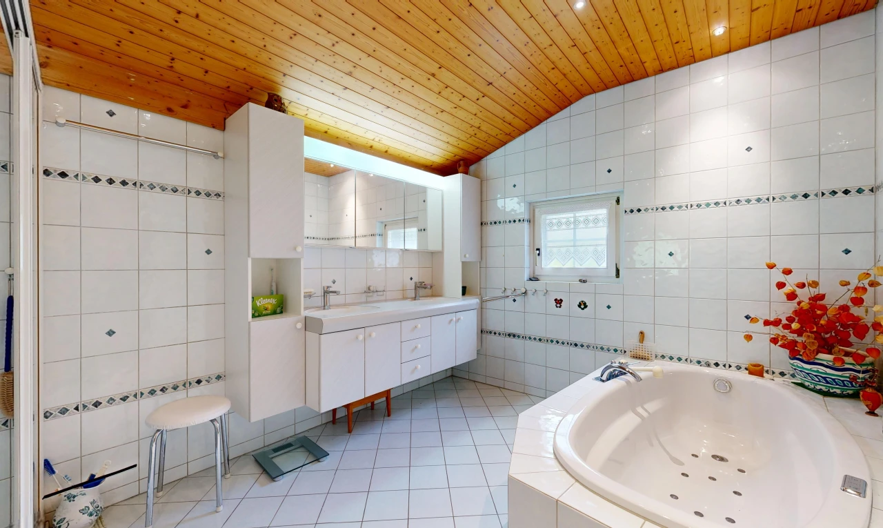 full bathroom with tile walls, a vaulted wood ceiling, a bath, double vanity, and light tile patterned floors