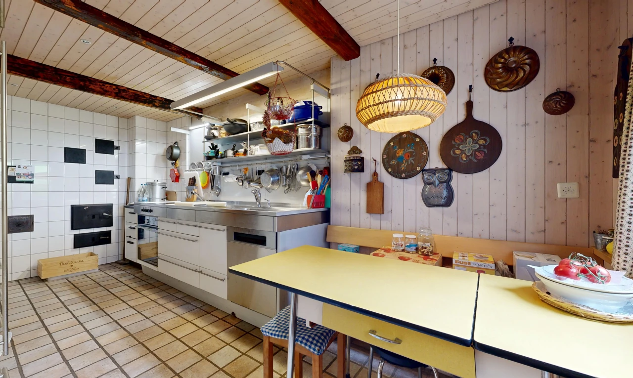kitchen featuring wood walls, black oven, dishwasher, and a wooden ceiling with exposed beams