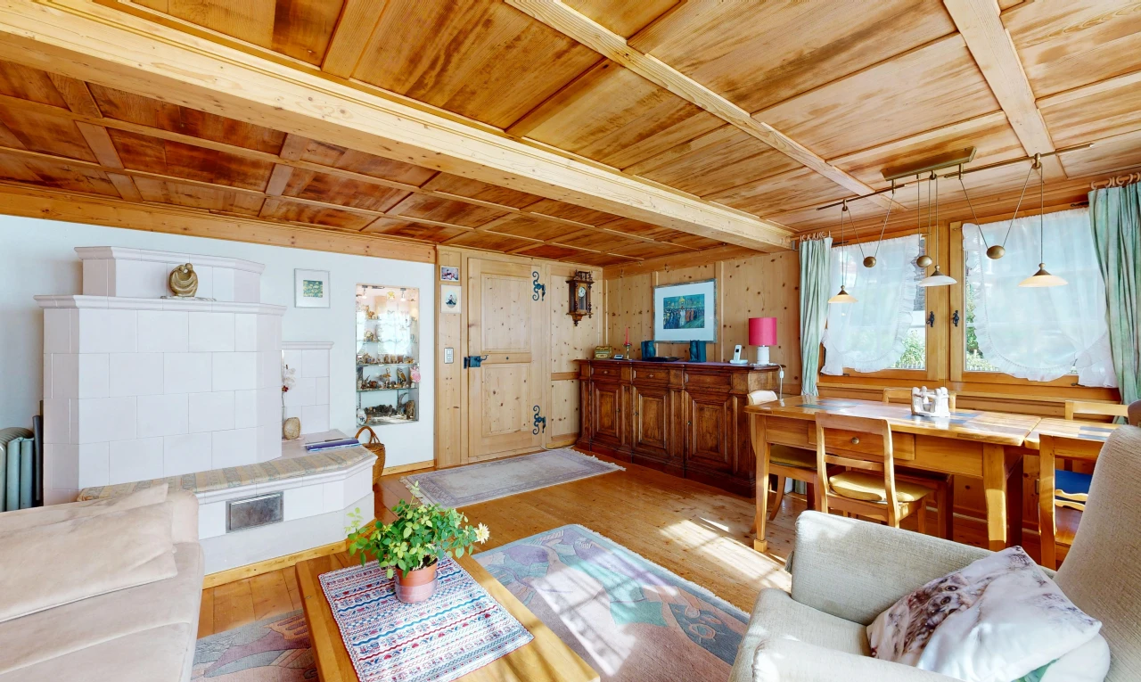 living area featuring a wood ceiling with exposed beams, wood finished floors, and decorative light fixtures