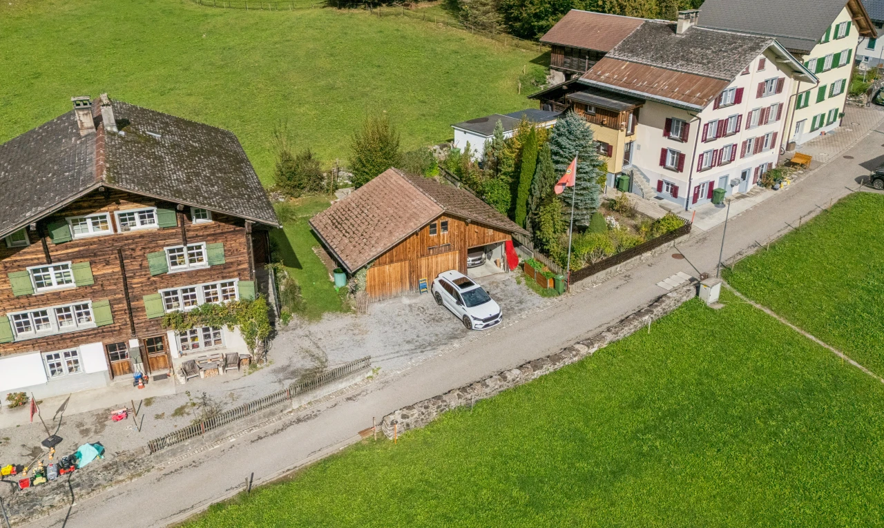 outdoor house with a lawn and an outdoor structure