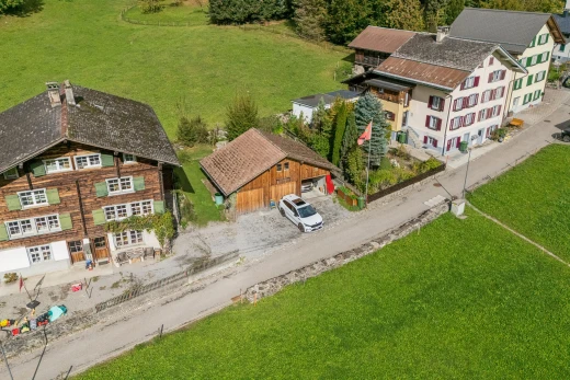 outdoor house with a lawn and an outdoor structure