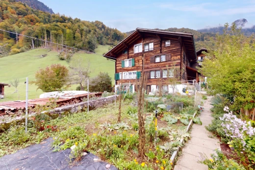 view of property with a wooded view