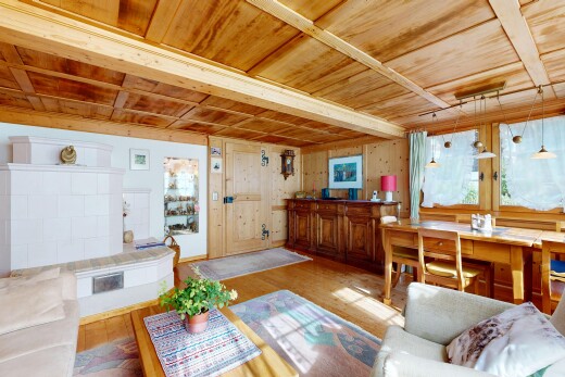 living area featuring a wood ceiling with exposed beams, wood finished floors, and decorative light fixtures