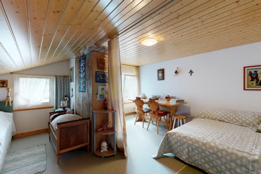 room featuring a vaulted wood ceiling, multiple windows, and light colored carpet