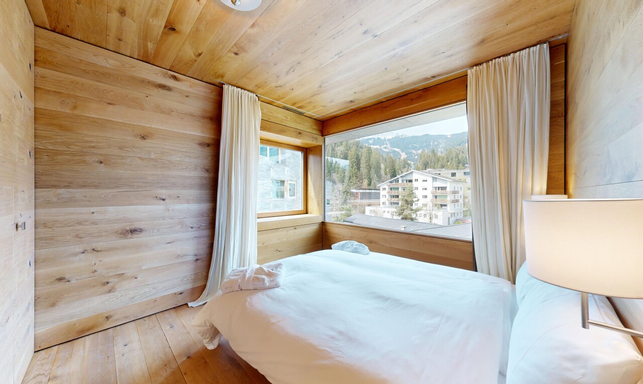 room / bedroom with wood-type flooring, wood ceiling, wooden walls, and a mountain view