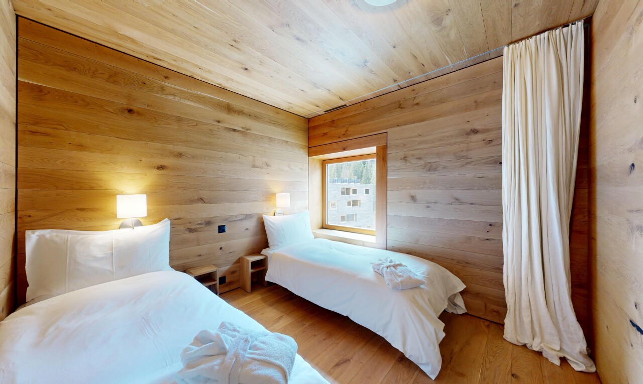 room / bedroom with wooden walls, light wood-style floors, and wood ceiling