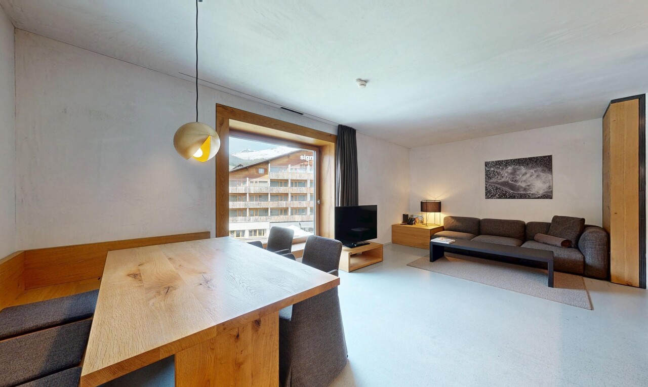 living area with a desk and finished concrete flooring