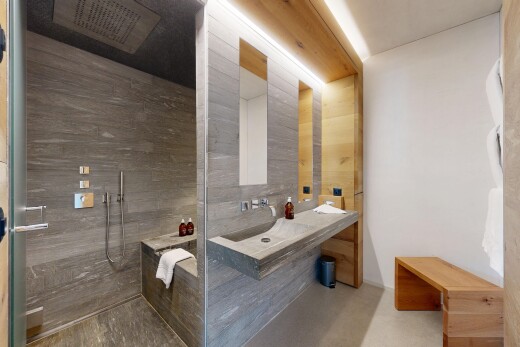 bathroom featuring finished concrete floors, walk in shower, and vanity