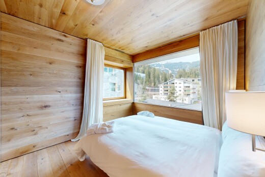 room / bedroom with wood-type flooring, wood ceiling, wooden walls, and a mountain view