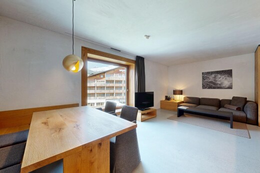 living area with a desk and finished concrete flooring