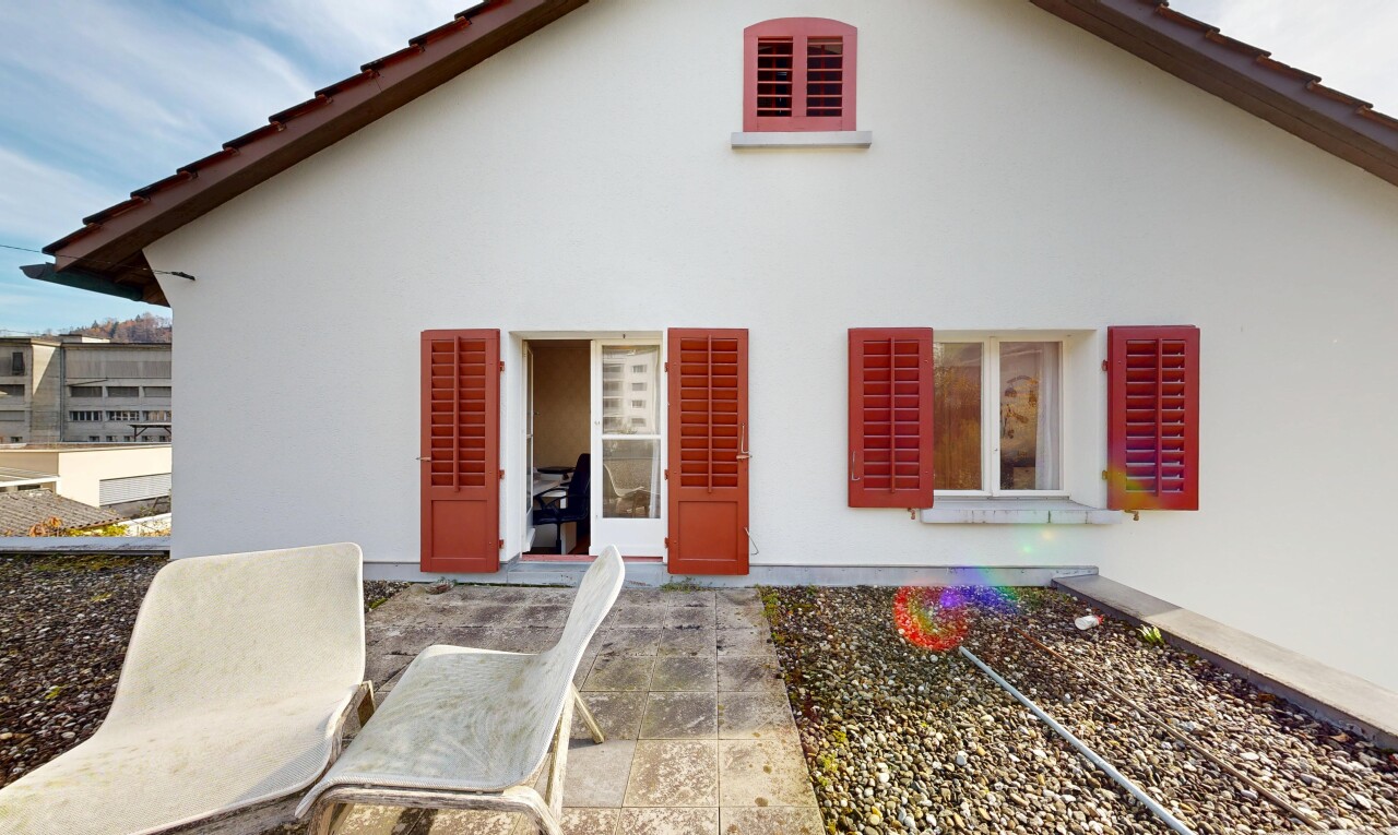 façade avec bardage en stuc, property visible, et day time