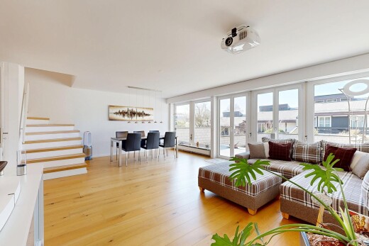 living area featuring light wood-style flooring and baseboard heating