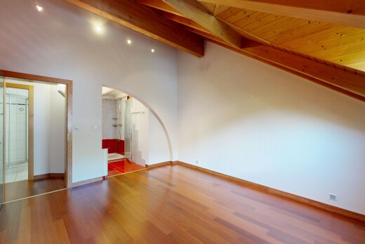 pièce vide avec éclairage sur rail, drywall, cloison sèche, passages en arc, et high end ceiling