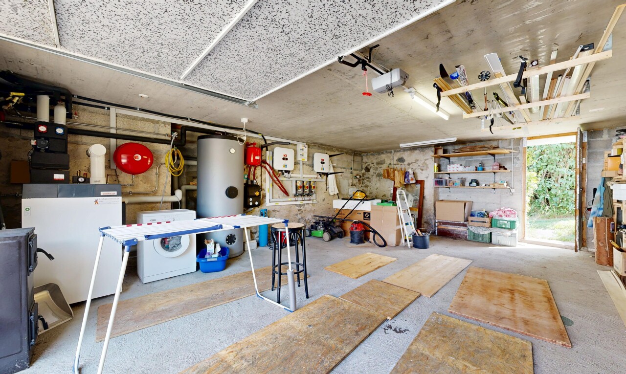 cuisine avec lave-linge et sèche-linge, inside property, sol en béton, concrete floor, et chauffe-eau