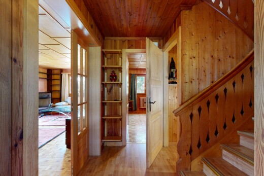 stairs with wood finished floors, wooden ceiling, and wood walls