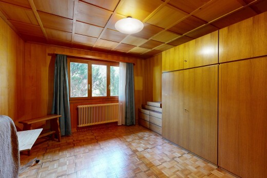 unfurnished room with radiator, a closet, parquet flooring, wood walls, and wood ceiling