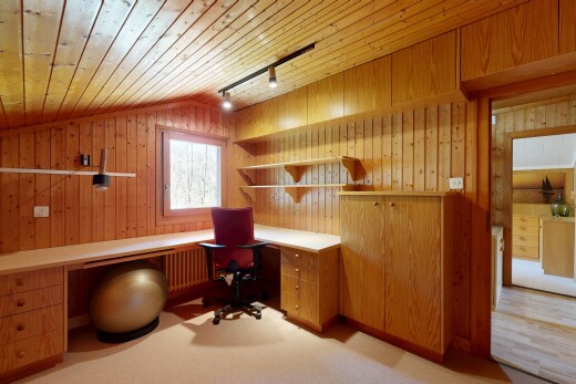 office featuring built in study area, track lighting, a vaulted wooden ceiling, radiator, and wooden walls