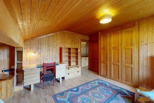 room / bedroom featuring wooden walls, light wood-type flooring, a desk, and a vaulted wood ceiling