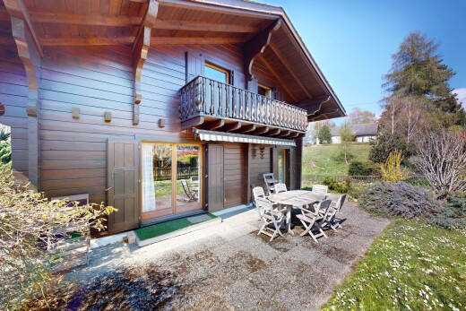 outdoor house with a balcony and outdoor dining space