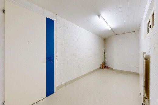 spare room featuring finished concrete floors and concrete block wall