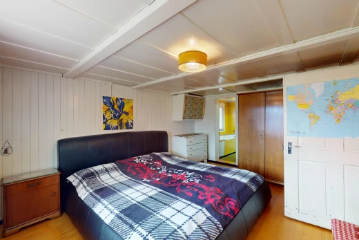 zimmer / schlafzimmer mit niedrige decke, kleiderschrank, und parkettboden