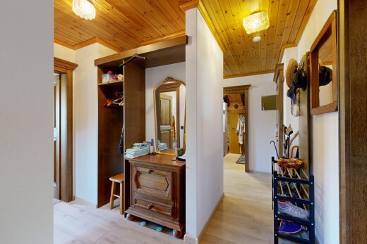 hall featuring wood ceiling, light wood-style flooring, and ornamental molding
