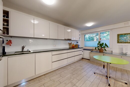 kitchen featuring modern cabinets, white cabinetry, open shelves, wood tiled floors, and dark countertops